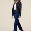 Jeans kick flare con fibbie metalliche
